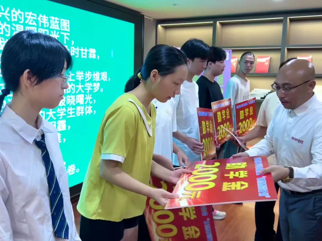 The Chairman of Boevan Packaging Machinery smiles as he presents a certificate to a young student during ceremony The Chairman of Boevan Packaging Machinery smiles as he presents a certificate to a young student during ceremony